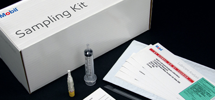An MLA sampling kit box and other equipment that can be found in a test kit on a table