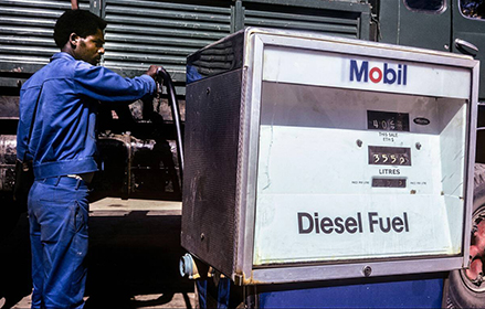 A man filling a diesel truck in Ethiopia