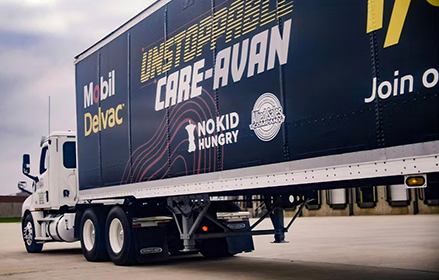 A lorry with the Mobil Delvac logo on the side and the unstoppable CARE-AVAN messaging