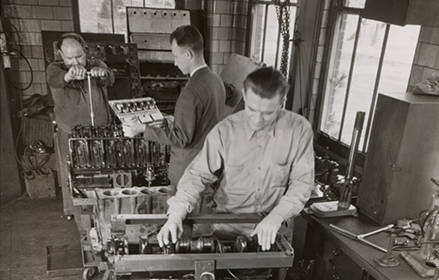 Mobil engineers inspecting an engine
