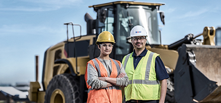 Mobil customers in front of an excavator